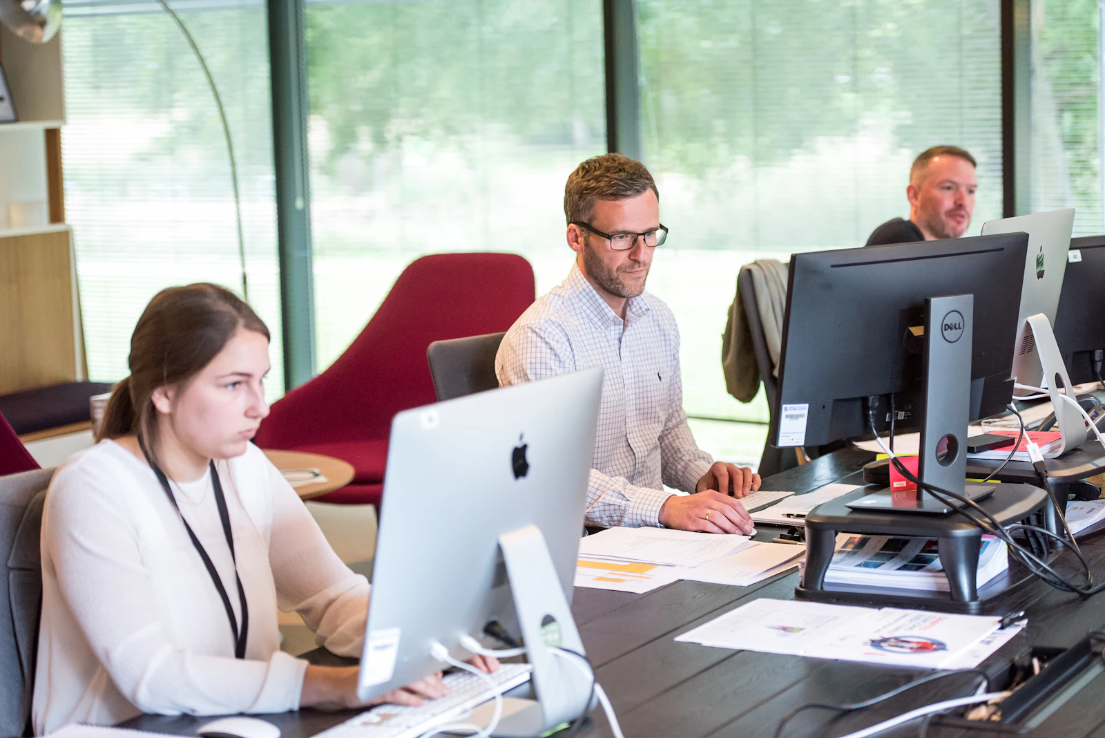 A small team working at desks in a bright office